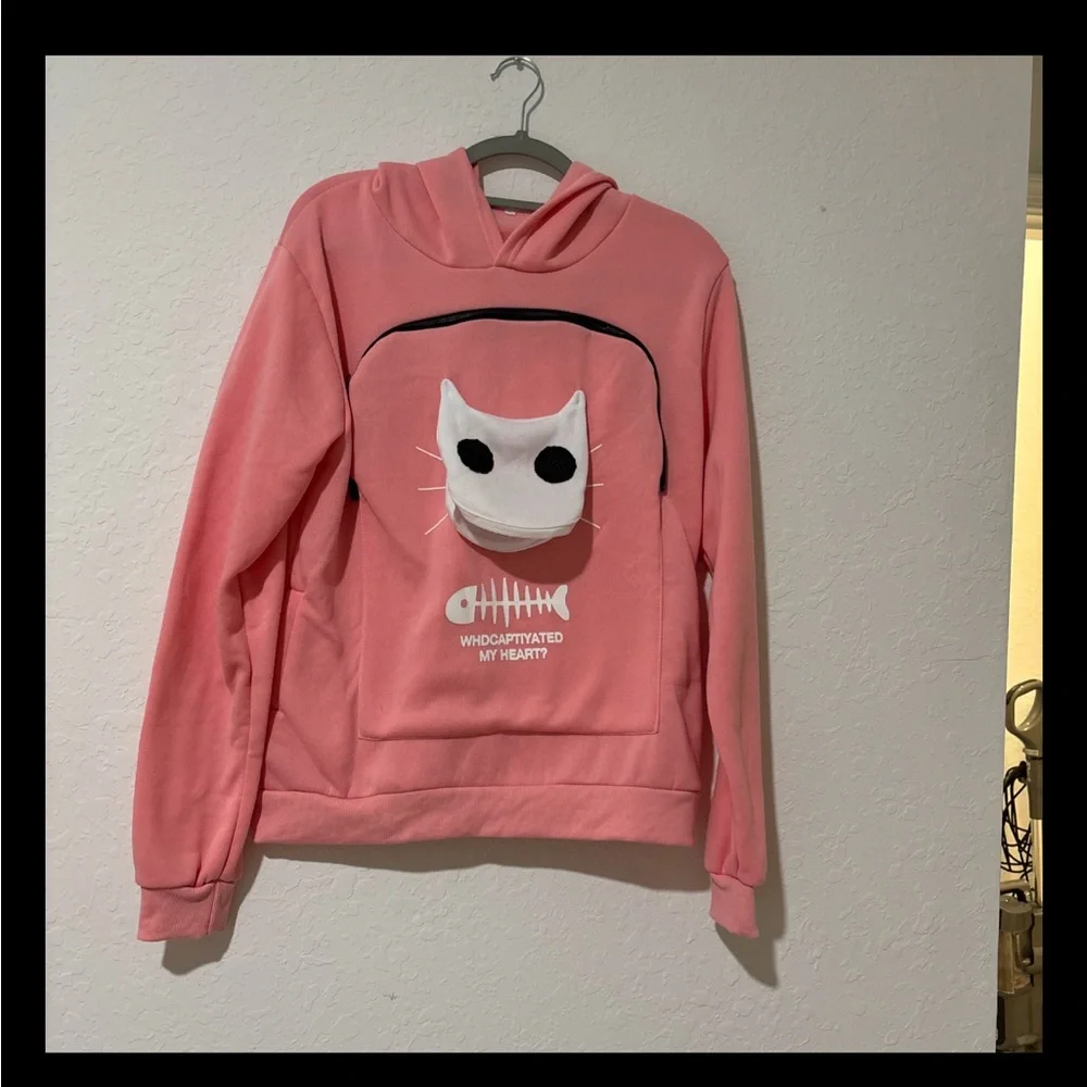 Pink sweatshirt that you can hold a small pet in.